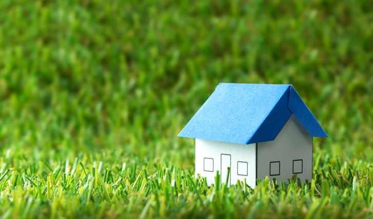 Small paper house in the grass